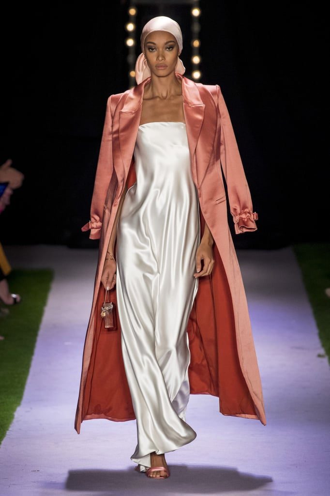 Model walking down the runway with a silk head scarf and silk slip dress. 