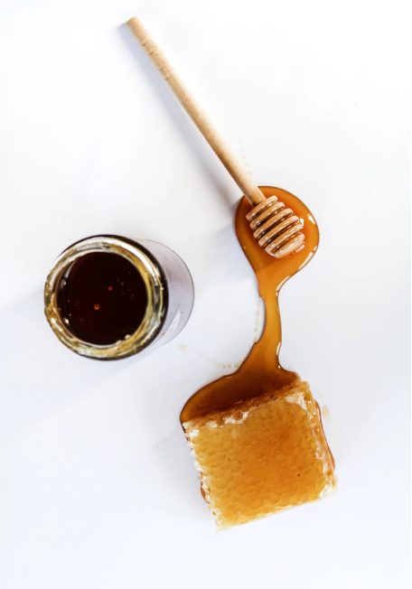 Honey comb with a jar of honey