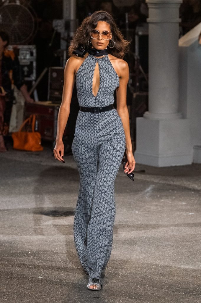Model walking down the runway during new york fashion week at Tommy Hilfiger show wearing a 70's inspired jumpsuit